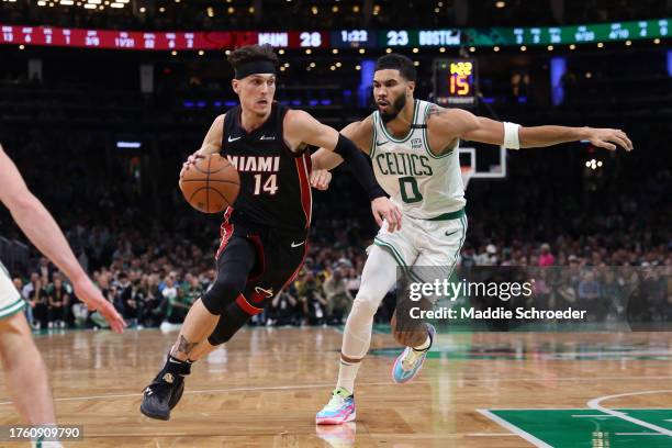 Tyler Herro of the Miami Heat drives to the basket past Jayson Tatum of the Boston Celtics at TD Garden on October 27, 2023 in Boston, Massachusetts....