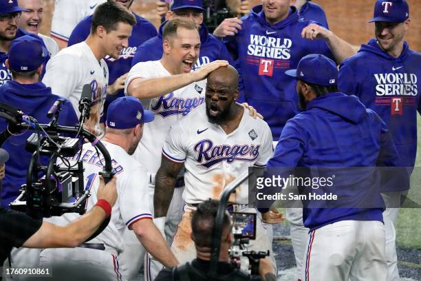 Adolis García of the Texas Rangers celebrates with teammates after hitting a home run in the 11th inning to beat the Arizona Diamondbacks 6-5 in Game...