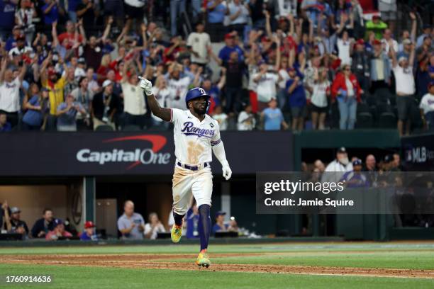 Adolis García of the Texas Rangers celebrates as he rounds the bases after hitting a home run in the 11th inning to beat the Arizona Diamondbacks 6-5...