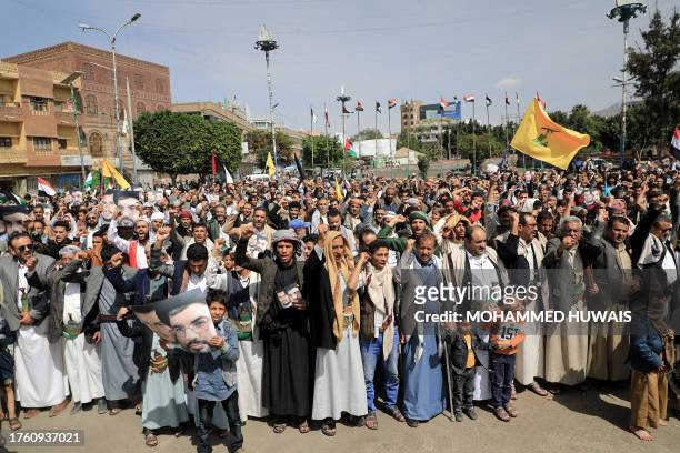 Yemenis raise the flag of the Lebanese Shiite movement Hezbollah during a solidarity rally with Palestinians in the Gaza Strip, in the Sanaa on...