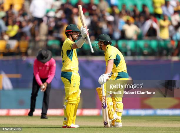 Travis Head of Australia celebrates after reaching his half century after hitting 50 runs with teammate David Warner during the ICC Men's Cricket...