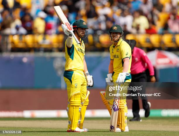 Travis Head of Australia celebrates after reaching his half century after hitting 50 runs with teammate David Warner during the ICC Men's Cricket...