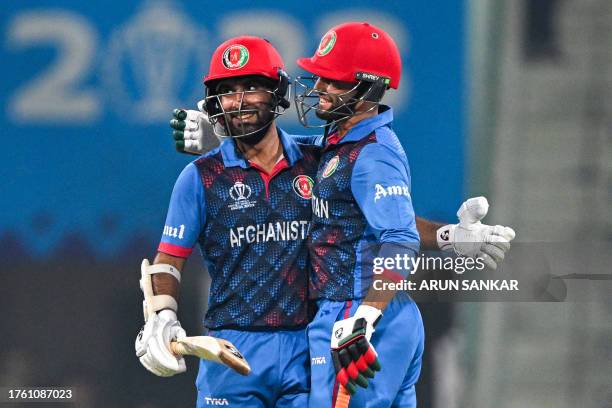 Afghanistan's captain Hashmatullah Shahidi celebrates after scoring a half-century with Azmatullah Omarzai during the 2023 ICC Men's Cricket World...