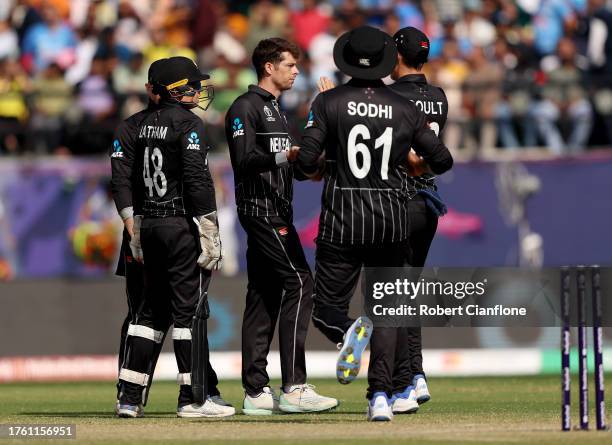 Mitch Santner of New Zealand celebrates with teammates after taking the wicket of Mitchell Marsh of Australia during the ICC Men's Cricket World Cup...