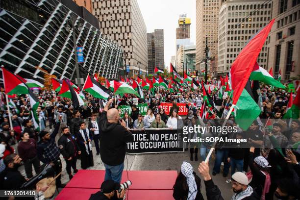Speaker addresses a massive crowd during a "Cease Fire on Gaza" rally. A massive gathering of over a thousand protesters from in and around Detroit...