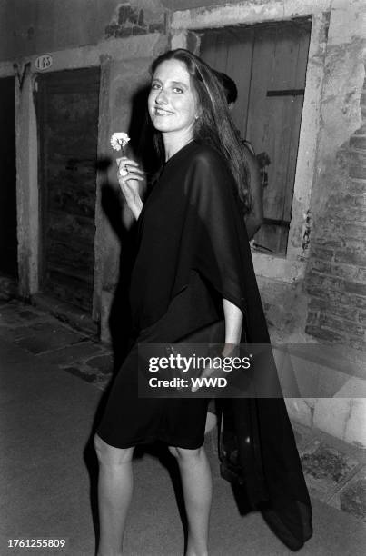 Marie Brandolini AKA Countess Marie Brandolini d'Adda di Valmareno holds flower given by attendants during dinner party after "Made in Milan" film...