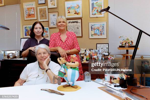 Ada Uderzo and his daugther Sylvie are photographed for Paris Match with Anne Goscinny in front of an Obelix figurine, on September 08, 2023 in...