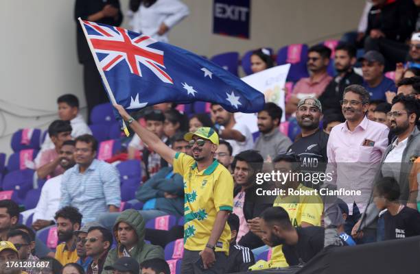 Fan of Australia waves a National Flag during the ICC Men's Cricket World Cup India 2023 Group Stage Match between Australia and New Zealand at HPCA...