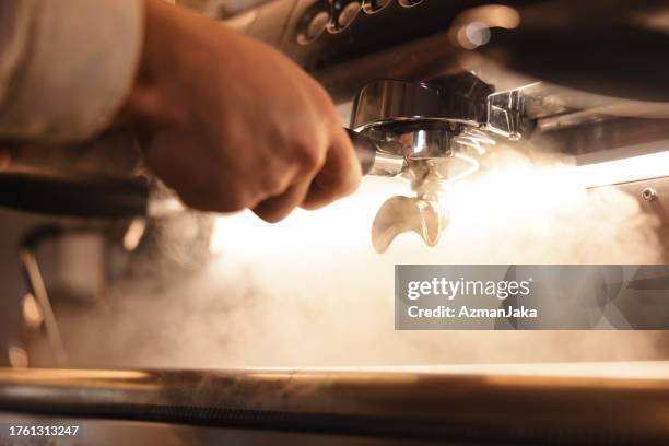 close up of coffee preparation on an espresso machine - barista stockfoto's en -beelden