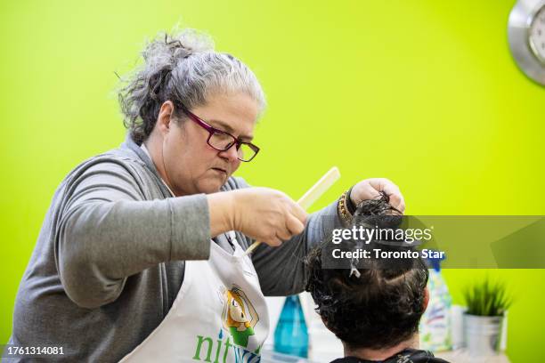 Toronto, ON Shawnda Walker, founder of Nitwits, a lice removal service, examines a clients hair. The resurgence of lice post-pandemic is causing a...