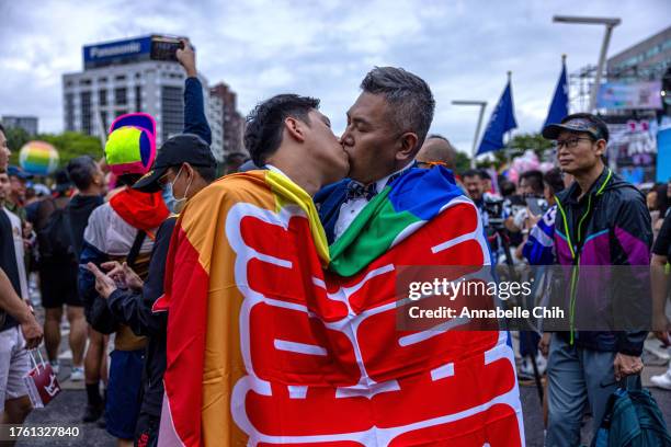 Couple kiss in front of the Taipei City Hall on October 28, 2023 in Taipei, Taiwan. The event, held in Taiwan annually, announces its status as one...