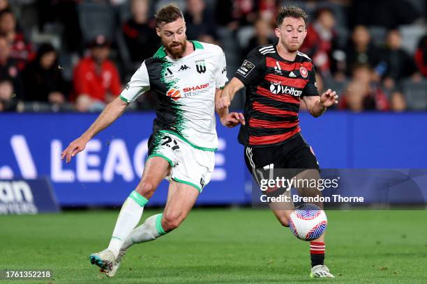 Lachlan Brook of the Wanderers competes with Jacob Tratt of Western United during the A-League Men round two match between Western Sydney Wanderers...