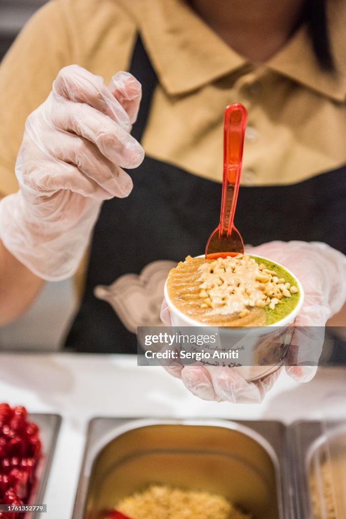Serving semolina halva with ice cream cup