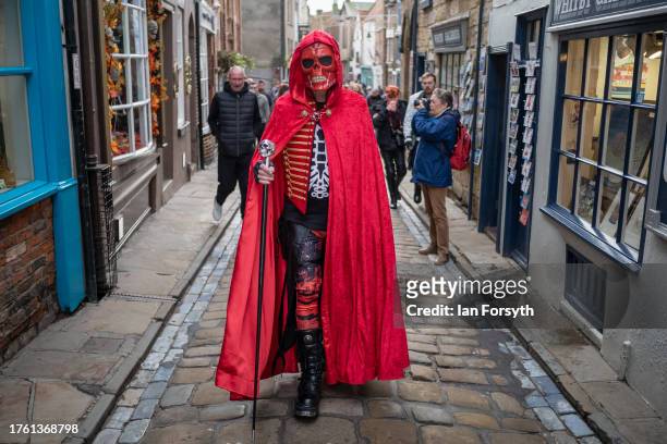 Man in a cape and skull mask attends Whitby Goth Weekend on October 28, 2023 in Whitby, England. The Whitby Goth Weekend is an alternative festival...