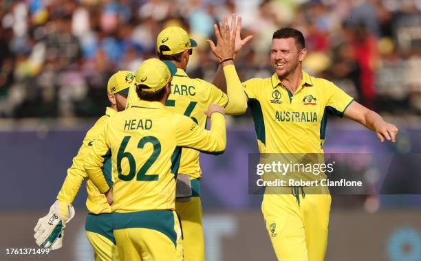 Josh Hazlewood of Australia celebrates with teammates after taking the wicket of Will Young of New Zealand during the ICC Men's Cricket World Cup...