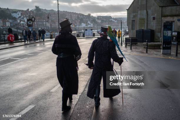 Couple wearing Gothic clothing attend Whitby Goth Weekend on October 28, 2023 in Whitby, England. The Whitby Goth Weekend is an alternative festival...