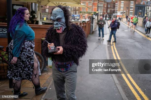 Stall holder in a mask writes out a receipt during Whitby Goth Weekend on October 28, 2023 in Whitby, England. The Whitby Goth Weekend is an...
