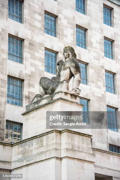 statue by the entrance of ministry of defence main building, london - department of defense stock pictures, royalty-free photos & images