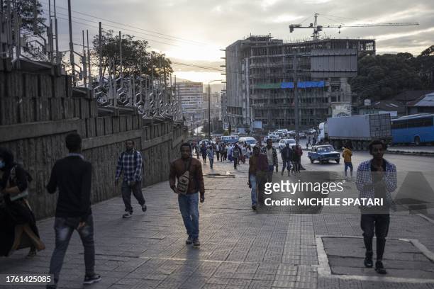 Pedestrian walk on a street of the historical Piazza neighbourhood of Addis Ababa on November 3, 2023.