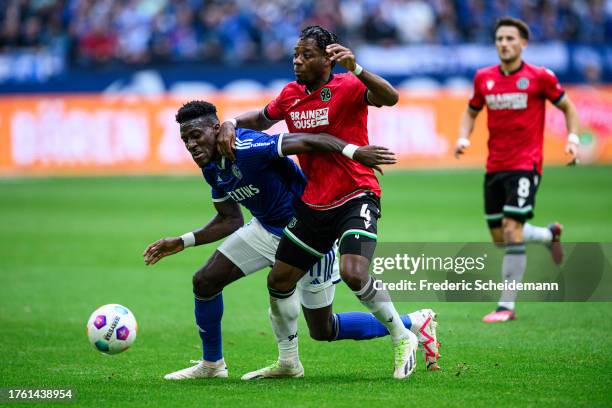 Bryan Lasme of Schalke is challenged by Bright Akwo Arrey Mbu of Hannover during the Second Bundesliga match between FC Schalke 04 and Hannover 96 at...