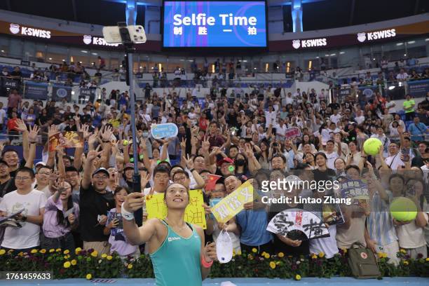 Qinwen Zheng of China takes a selfie pictures with fans after winning the women's singles semifinal matches against Lin Zhu of China on Day 5 of the...