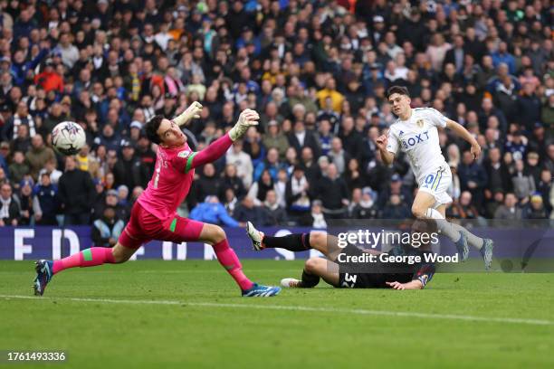 Daniel James of Leeds United scores the team's third goal past Tom Lees and Lee Nicholls of Huddersfield Town during the Sky Bet Championship match...