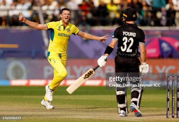 Josh Hazlewood of Australia celebrates after taking the wicket of Will Young of New Zealand during the ICC Men's Cricket World Cup India 2023 Group...