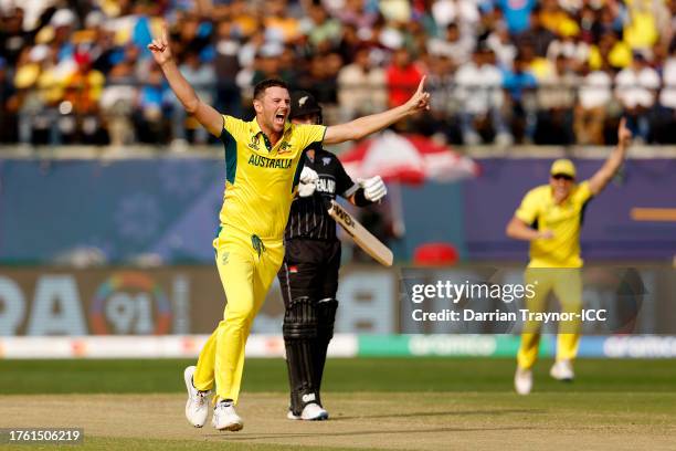 Josh Hazlewood of Australia celebrates after taking the wicket of Will Young of New Zealand during the ICC Men's Cricket World Cup India 2023 Group...