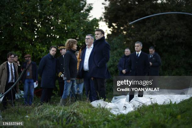 France's President Emmanuel Macron and French Interior Minister Gerald Darmanin look at the damages as they visit a farm in a region hit by Storm...