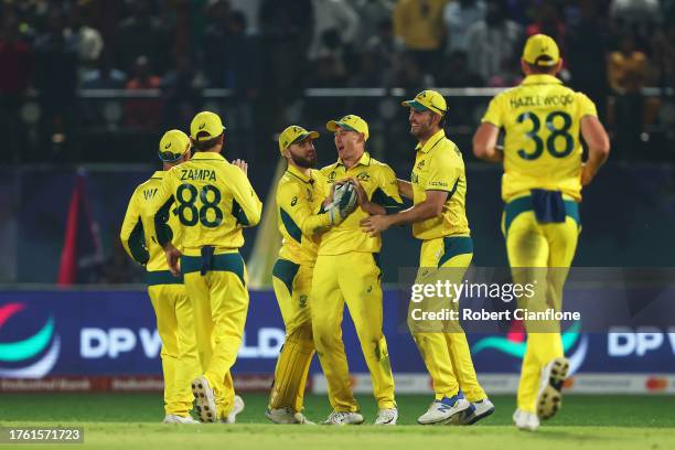 Players of Australia celebrate after taking the wicket of Jimmy Neesham of New Zealand from a throw from Marnus Labuschagne during the ICC Men's...