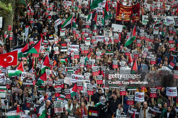 The march passes under embankment bridge on October 28, 2023 in London, England. A coalition of organisations, including the Palestine Solidarity...