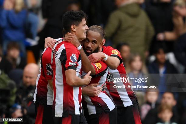 Bryan Mbeumo of Brentford celebrates with teammates after scoring the team's second goal during the Premier League match between Chelsea FC and...