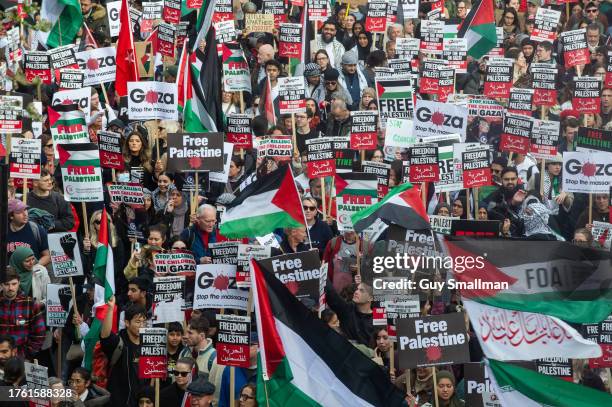 The march passes under embankment bridge on October 28, 2023 in London, England. A coalition of organisations, including the Palestine Solidarity...