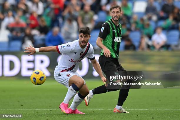 Riccardo Orsolini of Bologna FC competes for the ball with Matías Viña of US Sassuolo during the Serie A TIM match between US Sassuolo and Bologna FC...