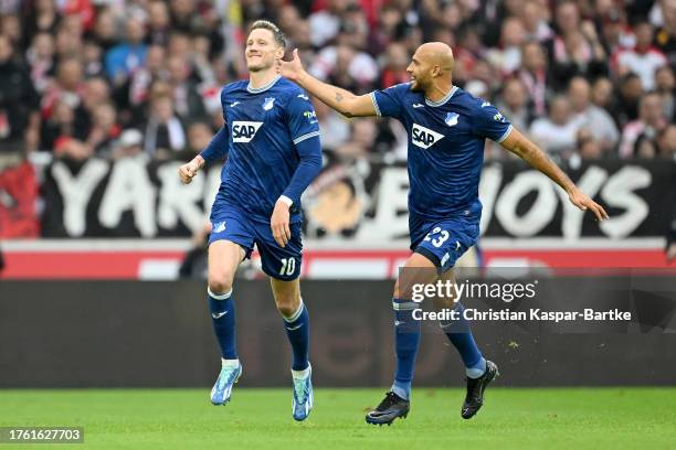 Wout Weghorst of TSG 1899 Hoffenheim celebrates with teammate John Brooks after scoring the team's second goal from the penalty spot during the...