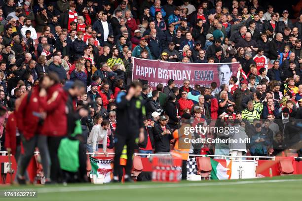 Fans of Arsenal hold a banner which reads 'happy birthday, Evan' in honour of American journalist Evan Gershkovich, prior to kick-off ahead of the...