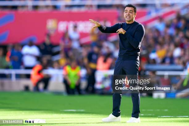 Xavi Hernandez, head coach of FC Barcelona gives instructions to their players during the LaLiga EA Sports match between FC Barcelona and Real Madrid...
