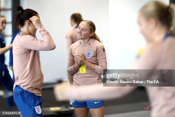 Katie Robinson and Lucy Bronze of England talk in the gym at St George's Park on October 28, 2023 in Burton upon Trent, England.