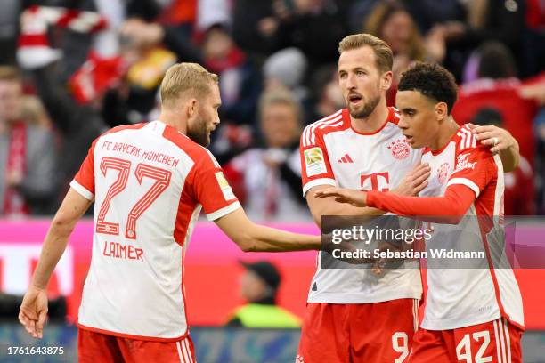 Jamal Musiala of Bayern Munich celebrates with Konrad Laimer and Harry Kane of Bayern Munich after scoring the team's seventh goal during the...