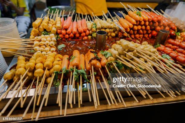 skewers for sale on night market in bangkok - skewer stock pictures, royalty-free photos & images