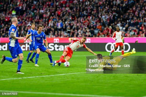 Harry Kane of Munich scores his team's eights goal against Marcel Schuhen of Darmstadt during the Bundesliga match between FC Bayern München and SV...