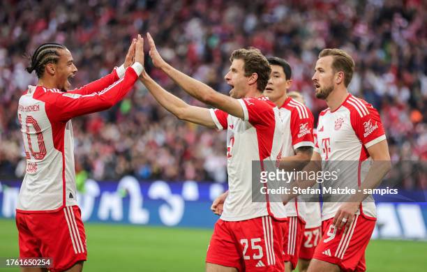 Thomas Mueller of Bayern Muenchen celebrates as he scores the goal 6:0 with Leroy Sane of Bayern Muenchen during the Bundesliga match between FC...