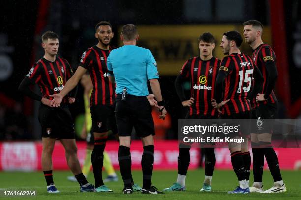 Lloyd Kelly of AFC Bournemouth complains to Referee Sam Barrott while waiting for a VAR check after Jay Rodriguez of Burnley scored a goal, which was...