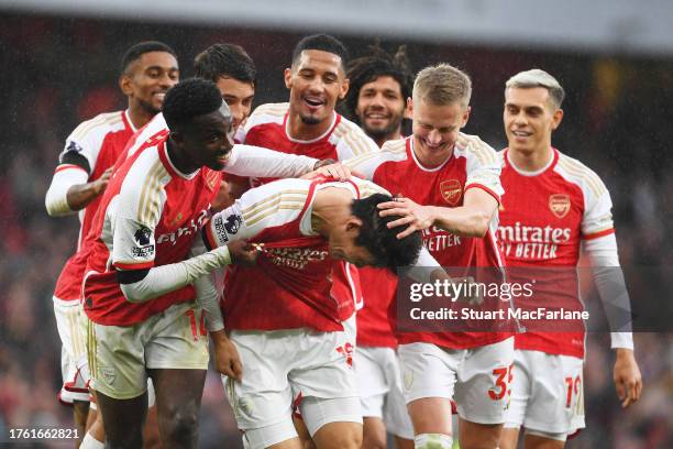 Takehiro Tomiyasu of Arsenal celebrates with teammates after scoring the team's fifth goal during the Premier League match between Arsenal FC and...