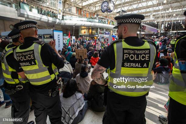 British transport Police look on as hundreds of activists blockade Waterloo station in protest at the bombing of Gaza on October 28, 2023 in London,...