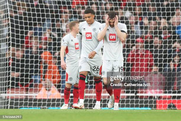 Jack Robinson of Sheffield United looks dejected as Takehiro Tomiyasu of Arsenal scores the team's fifth goal during the Premier League match between...