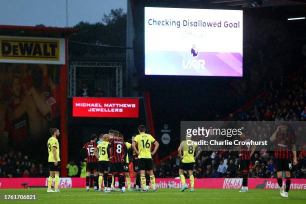 Players wait as VAR takes five minutes to make a call on a disallowed Jay Rodriguez goal for Burnley during the Premier League match between AFC...
