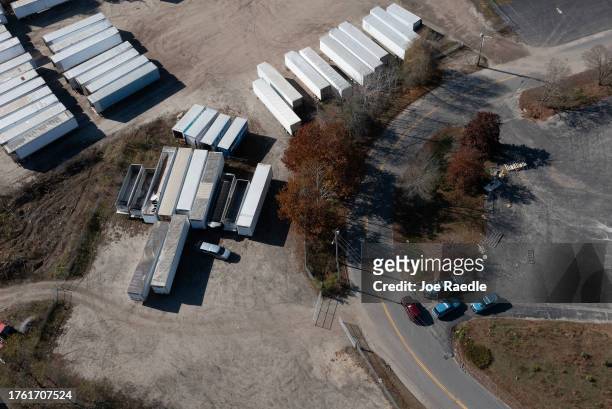 In an aerial view, law enforcement officials are seen investigating the area where Robert Card, the suspect in two mass killings, was found dead on...