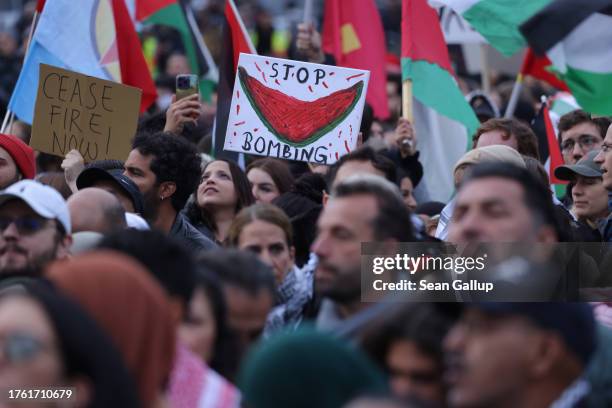 People wave Palestinian flags and hold a picture of a watermelon as they gather for a "Global South United" protest to demand freedom for Palestine...