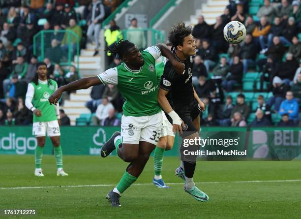 Rocky Bushiri of Hibernian vies with Oh Hyeongyu of Celti during the Cinch Scottish Premiership match between Hibernian FC and Celtic FC at Easter...